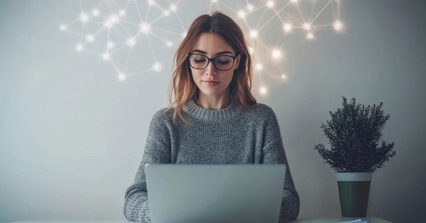 Woman in a cozy sweater using a laptop to explore mental clarity focus benefits of sea moss