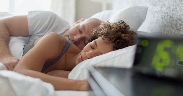 Couple peacefully sleeping in bed showing natural sleep aids for midlife promoting restful sleep